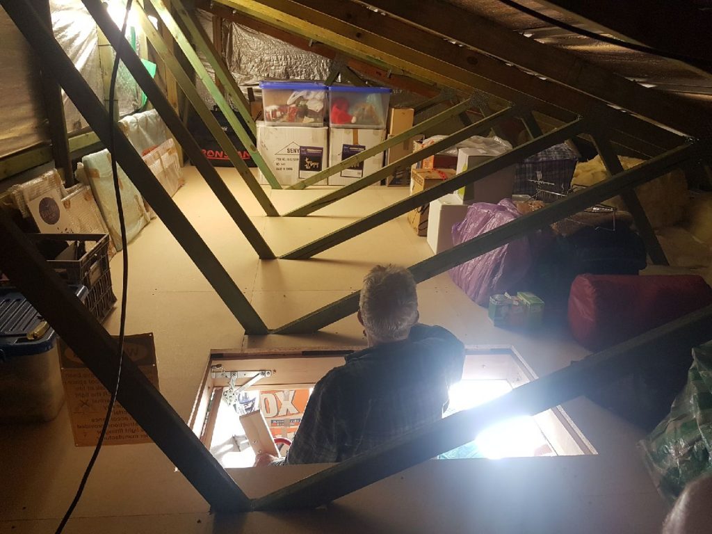 Resized_20170602_124152-1024×768 Man looking at attic storage.