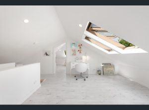 Fakro roof windows in open position, filling attic office area with natural light